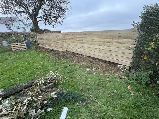 Long run of new horizontal timber fencing along a garden boundary. One of our jobs.