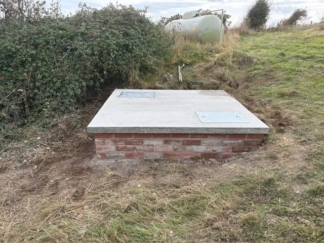 Brick chamber finished with a concrete cover in a grass verge. One of our jobs.